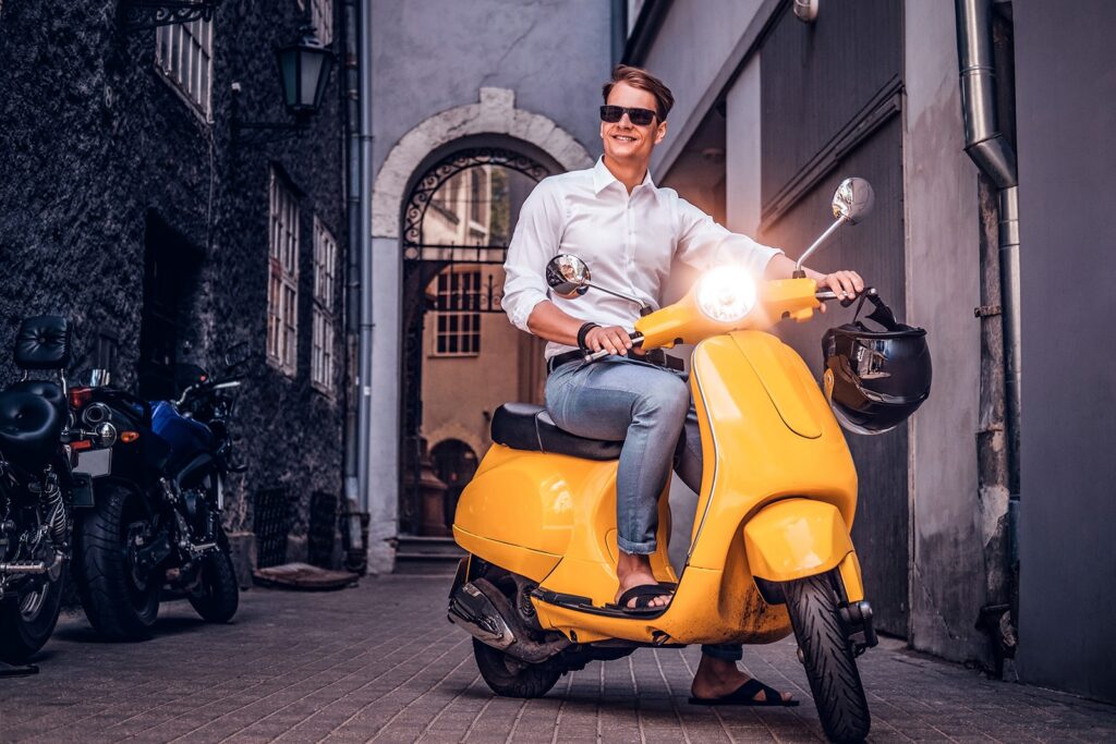 handsome-man-riding-on-vintage-italian-scooter-in